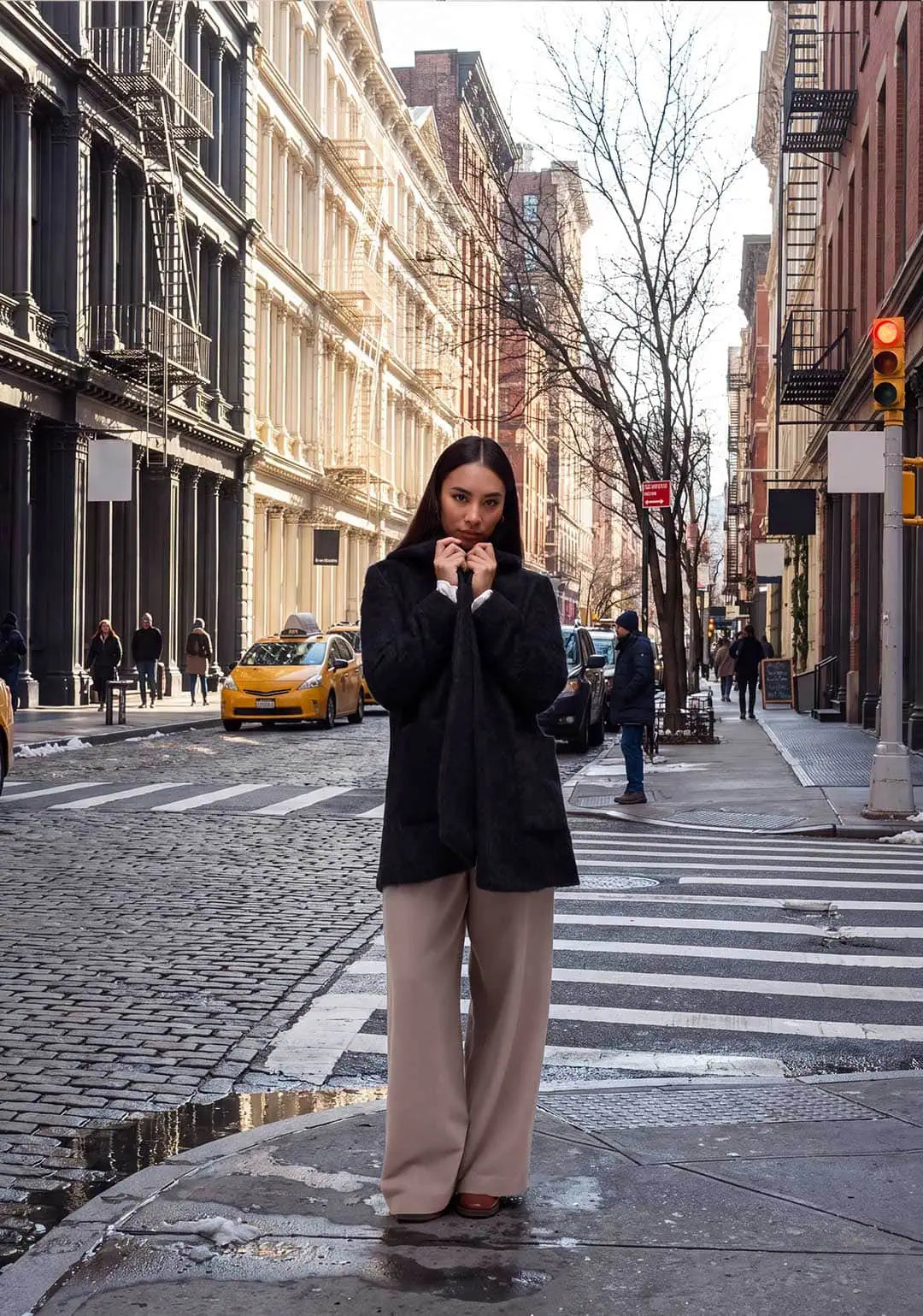 A New York City Wardrobe for Winter, Built to Last. A woman wearing a black alpaca short winter coat in Soho NYC.