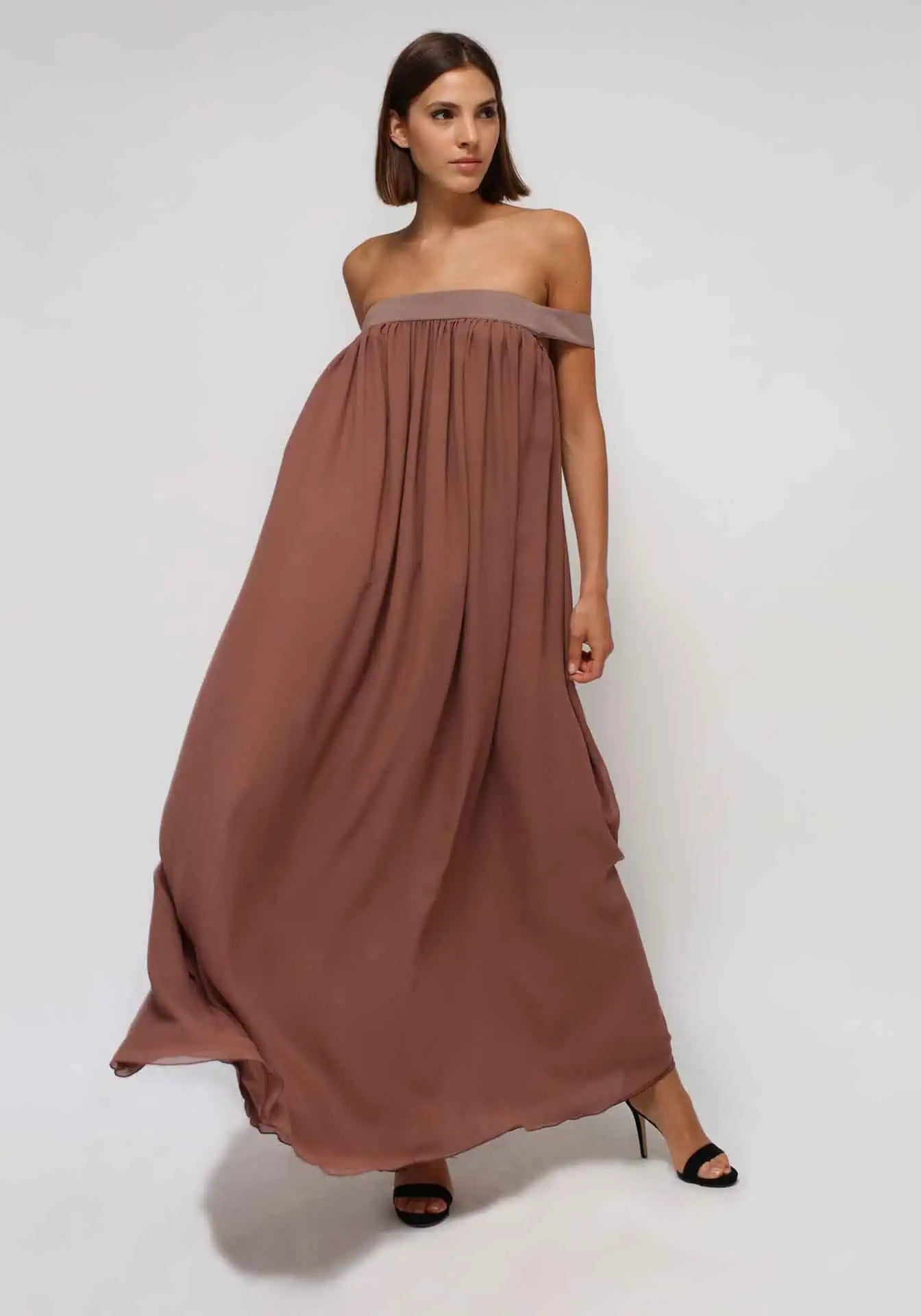 A woman wearing a brow silk dress. Chiffon from Humans & Land