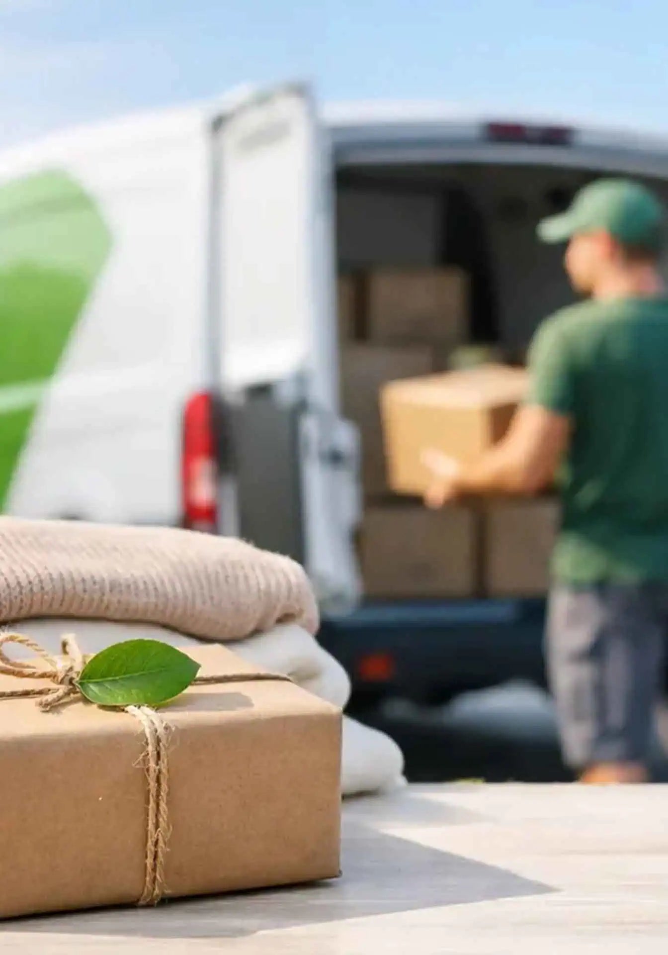 Carbon free shipping with a man loading a delivery van