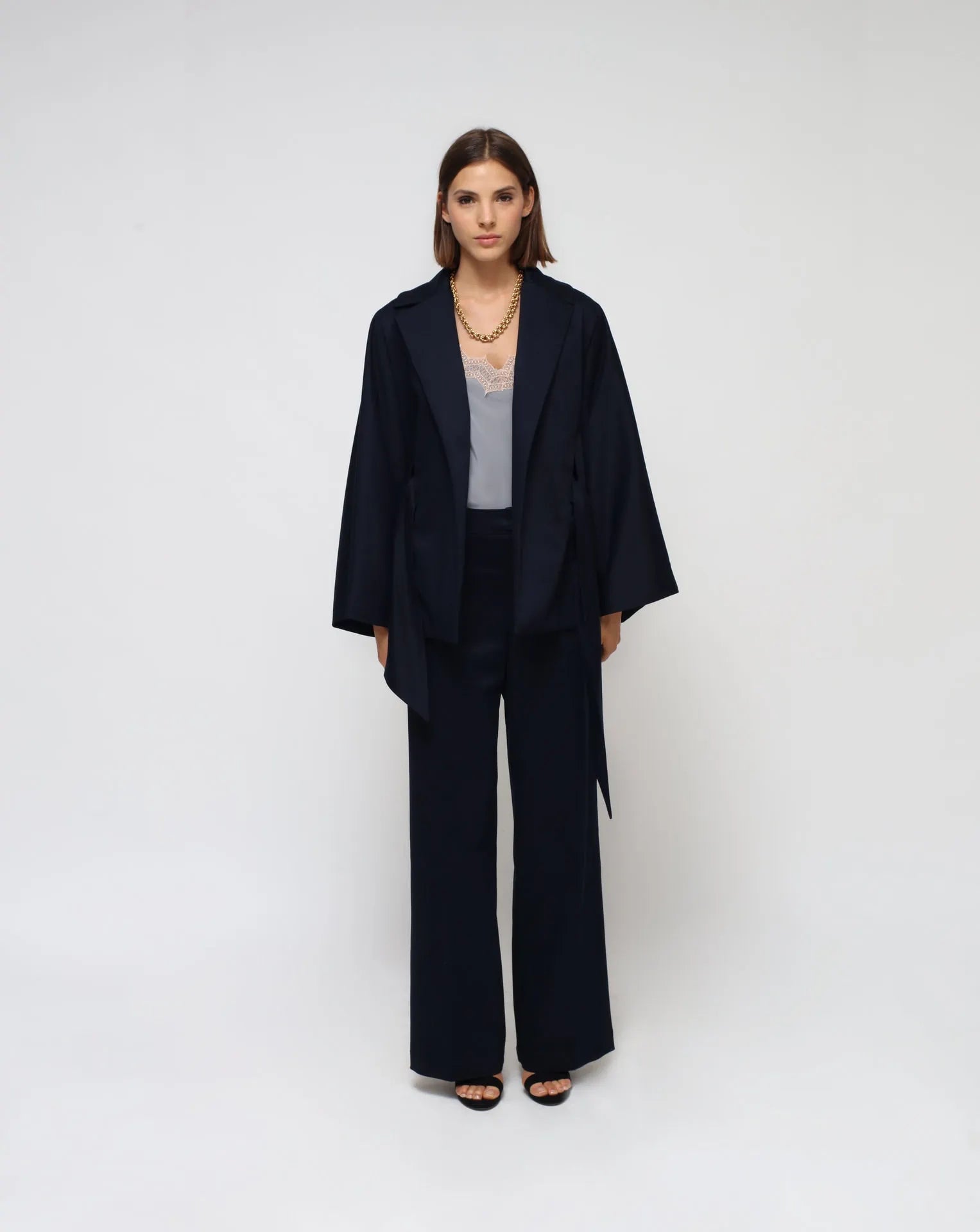 Woman wearing a blue outfit with a white background