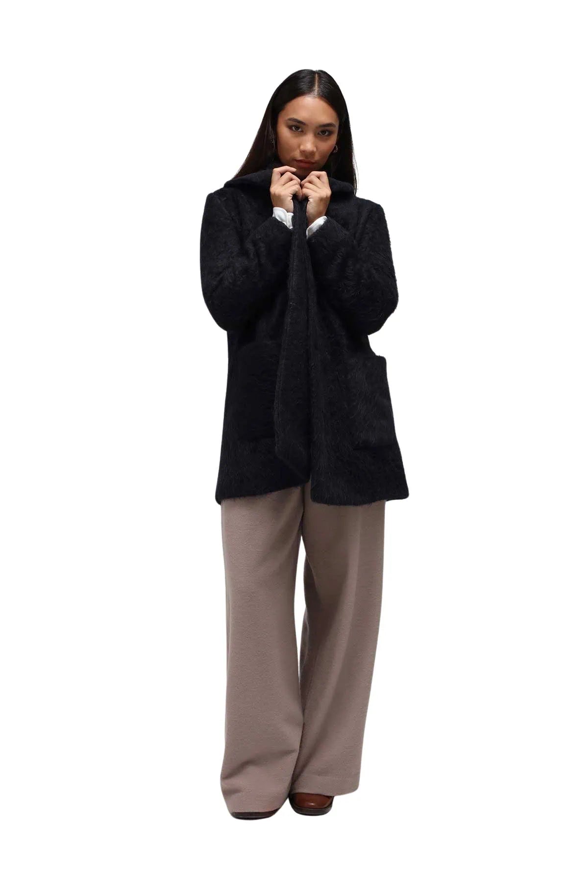 A woman wearing a black winter short coat on a white seamless background