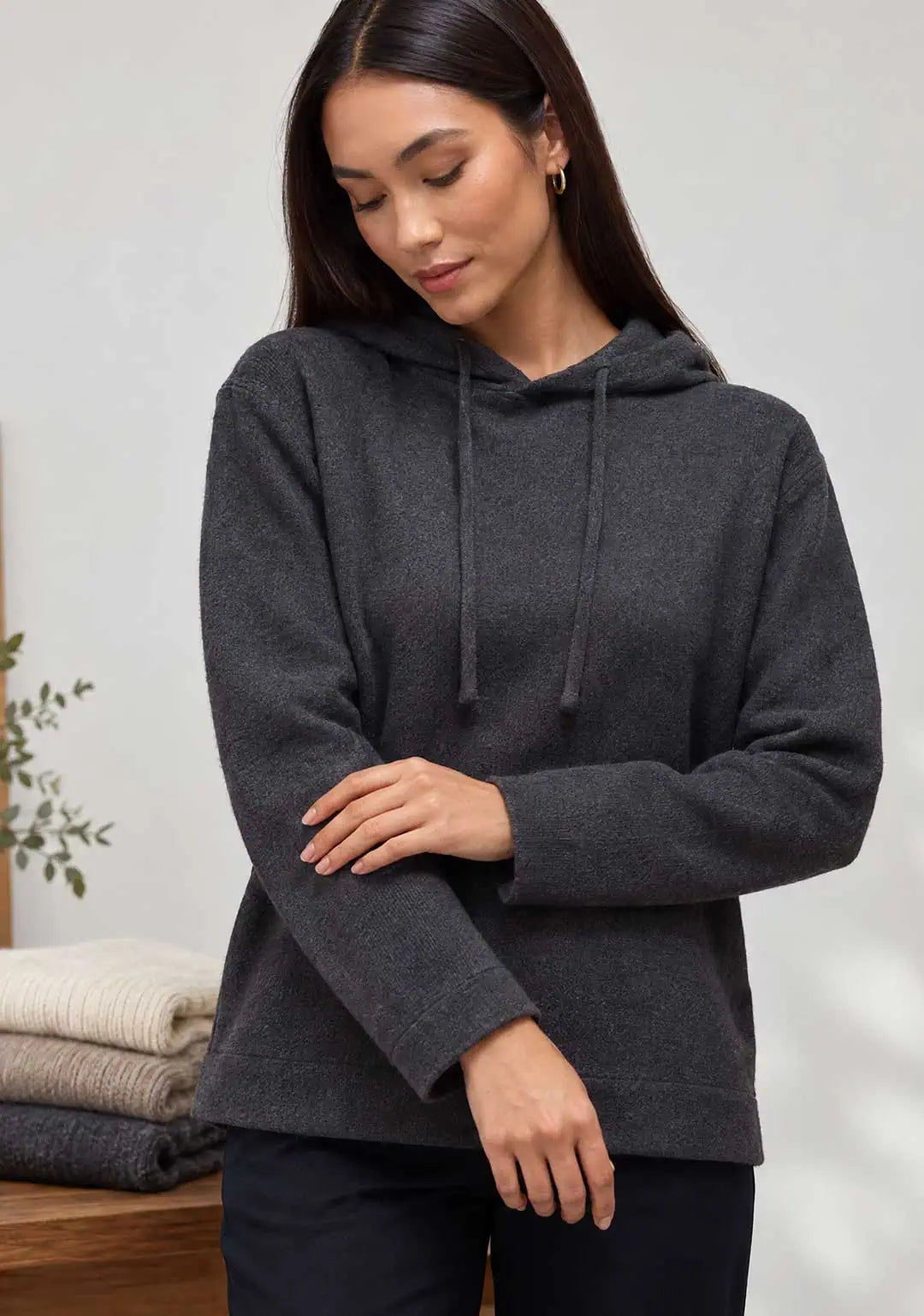 How to Care for Cashmere: A Lasting Winter Layer. A woman wearing a cashmere hoodie by Humans & Land