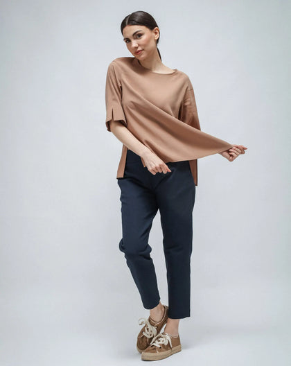 Woman in cupro shirt in nude color